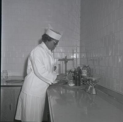 Fenwick Wilson conducts quality assurance work on pickles packed at Vita Foods plant
