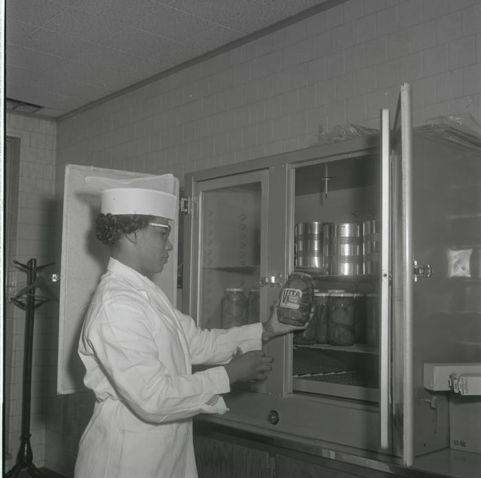 Geraldine Brooks - Fenwick inspects a jar of pickles for Vita Foods production