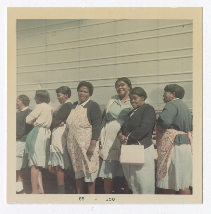 Mary Smith, Elaine Hopkins, Flora "Babe" Goldsboro, Rosie Goldsboro, Mae Ashe, Viola Massey "Aunt Sis", and an unknown woman pose in front of a VITA Food truck.