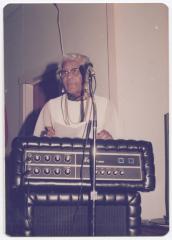 Woman speaking behind an amplifier