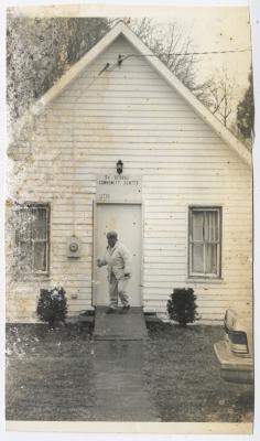 A woman closing the door to St. George's Community Center
