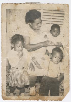A woman and three young children