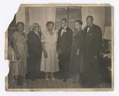 Six dressed up people standing together