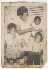 A woman and three young children