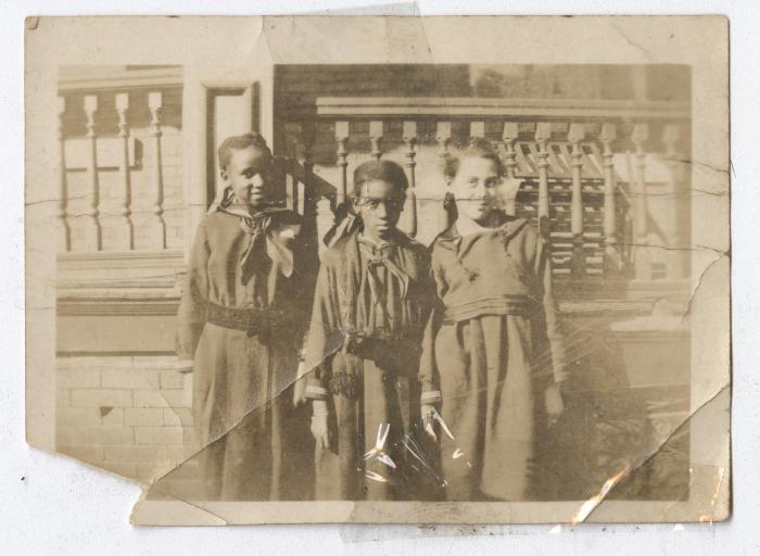 Three girls in long smock dresses