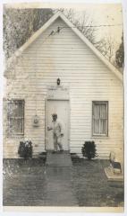 A woman closing the door to St. George's Community Center