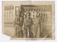 Three girls in long smock dresses