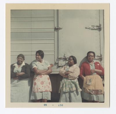Mildred Griffin, Anna Louise Ringgold "Piggy", Florence Jones, and Marjorie Gilbert - VITA Foods employees leaning against a truck