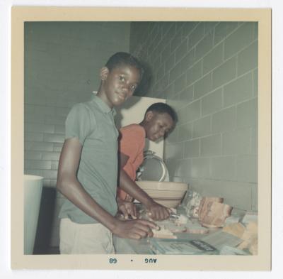 Edward "Woodie" Rowe and Marvin Rowe making sandwiches