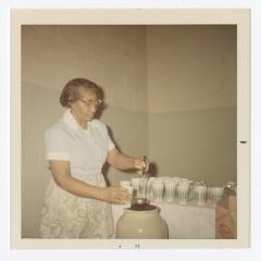 Rose McGreer serving punch during Christmas dinner,December 3, 1971