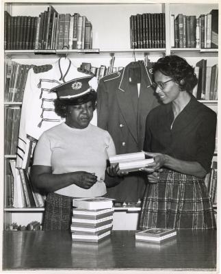 Amanda Frisby Bessick and Gertrude Reid sorting through books