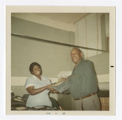 Florence Tinch handing out VITA Foods uniforms