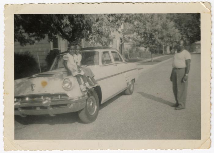 Girls sitting on a car