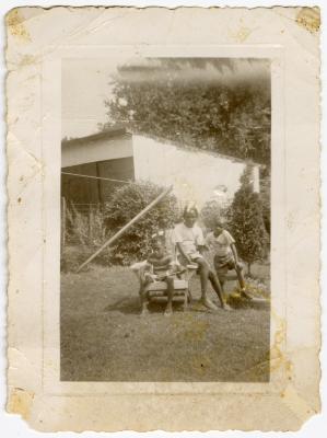 Three children posing for photograph outside