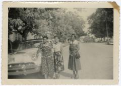 Women standing near an automobile on Calvert Street