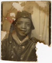 Child wearing an aviator jacket and hat