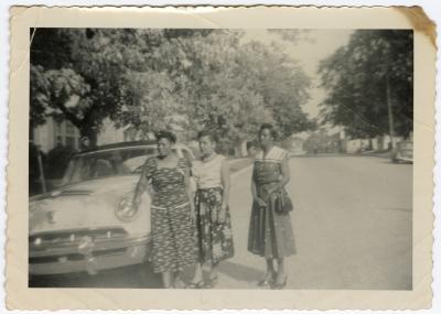 Women standing near an automobile on Calvert Street
