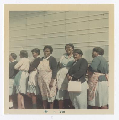 Mary Smith, Elaine Hopkins, Flora "Babe" Goldsboro, Rosie Goldsboro, Mae Ashe, Viola Massey "Aunt Sis", and an unknown woman pose in front of a VITA Food truck.