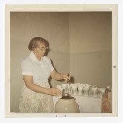 Rose McGreer serving punch during Christmas dinner,December 3, 1971