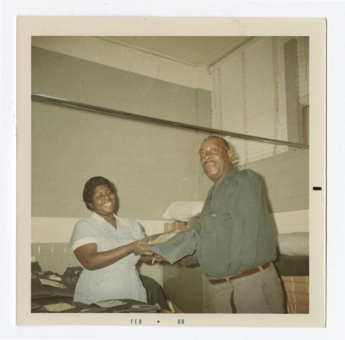 Florence Tinch handing out VITA Foods uniforms