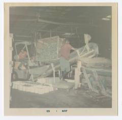 James "Jimmy" Sampson on the left is dumping pickles with the help of another worker.