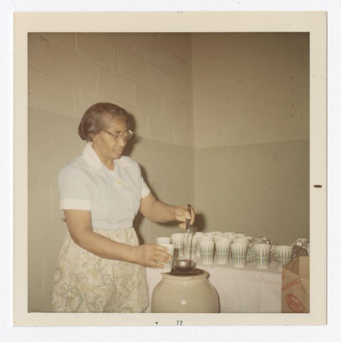 Rose McGreer serving punch during Christmas dinner,December 3, 1971