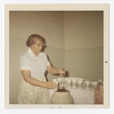 Rose McGreer serving punch during Christmas dinner,December 3, 1971