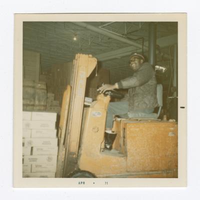 Harold Sisco driving a new electric forklift, April 1971
