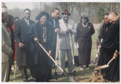 Five people breaking ground