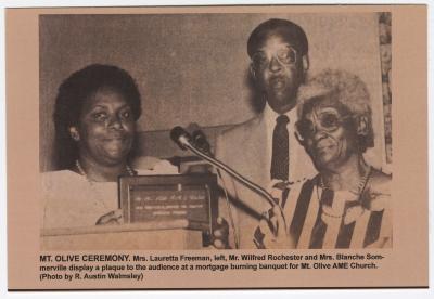 Displaying a plaque at a mortgage-burning ceremony