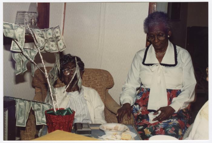 Two women by a money tree