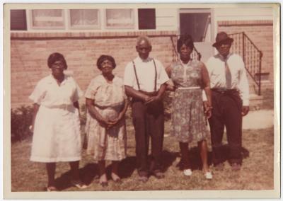 Reverend Albert Walker and family in front of Cheryl Saunders' home