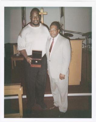 Two men at the church altar with a box
