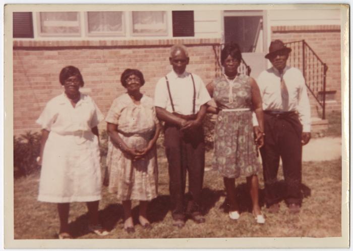Reverend Albert Walker and family in front of Cheryl Saunders' home