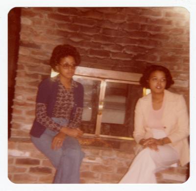 Airlee Ringgold Johnson and Muriel Lucretia Ringgold Thomas sitting by a fireplace