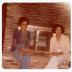 Airlee Ringgold Johnson and Muriel Lucretia Ringgold Thomas sitting by a fireplace