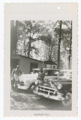 Jimmy Manuel and Sam Ringgold posing with cars at Sparrow's Beach