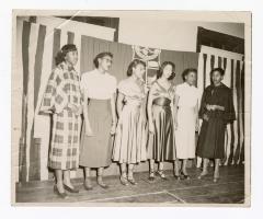 Six formally dressed women