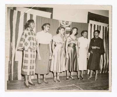 Six formally dressed women