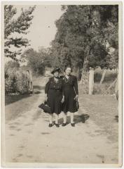 Two women outside cemetery 