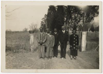 Six individuals beside cemetary