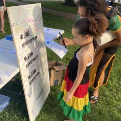 Woman and young girl viewing the Community Commitment Mural