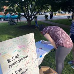 Signing the Community Commitment Mural at We Stand: Day of Agreement