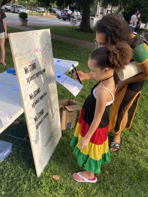 Woman and young girl viewing the Community Commitment Mural