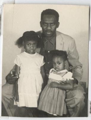 Black and white photograph of a man with two young girls