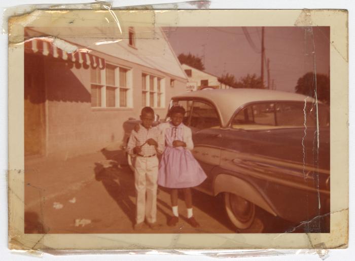 Brian Graves and Margo Murray (cousin to Monica Graves) standing in front of the Uptown Club.