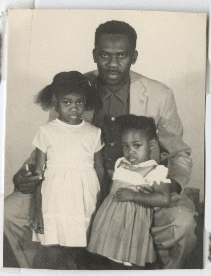 Black and white photograph of a man with two young girls