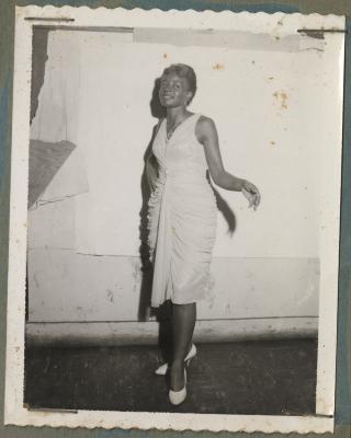 Black and white photo of a young woman in formal dress