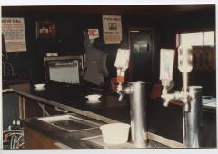 Charlie Graves, owner, installing a sign in the Uptown Club.