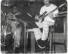 Photograph of Corey "Fat Cat" Hackett at drum with guitarist, 1977